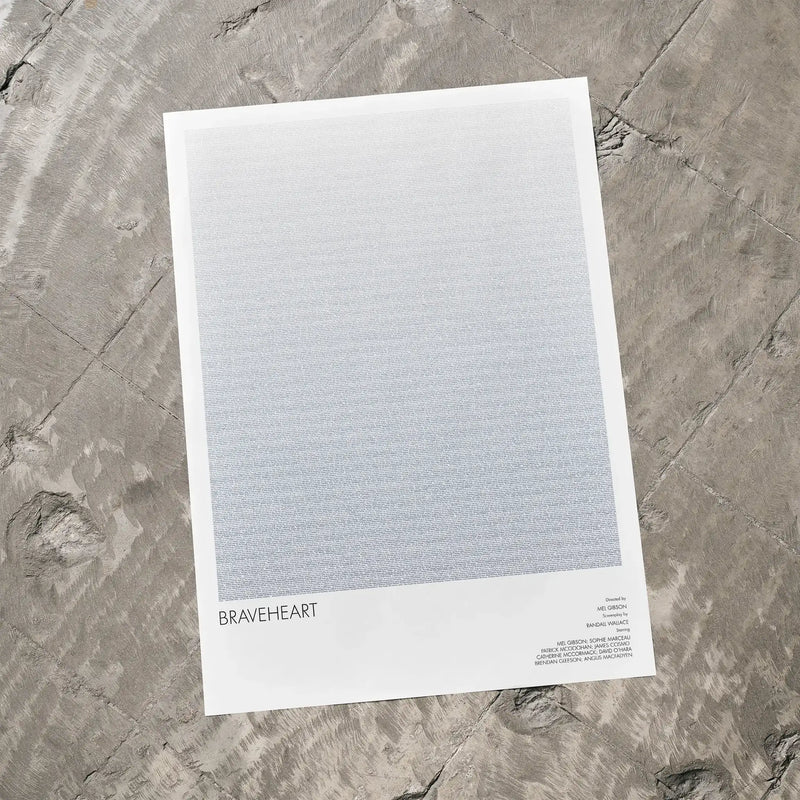 A Braveheart movie script poster laid flat on a textured floor surface.