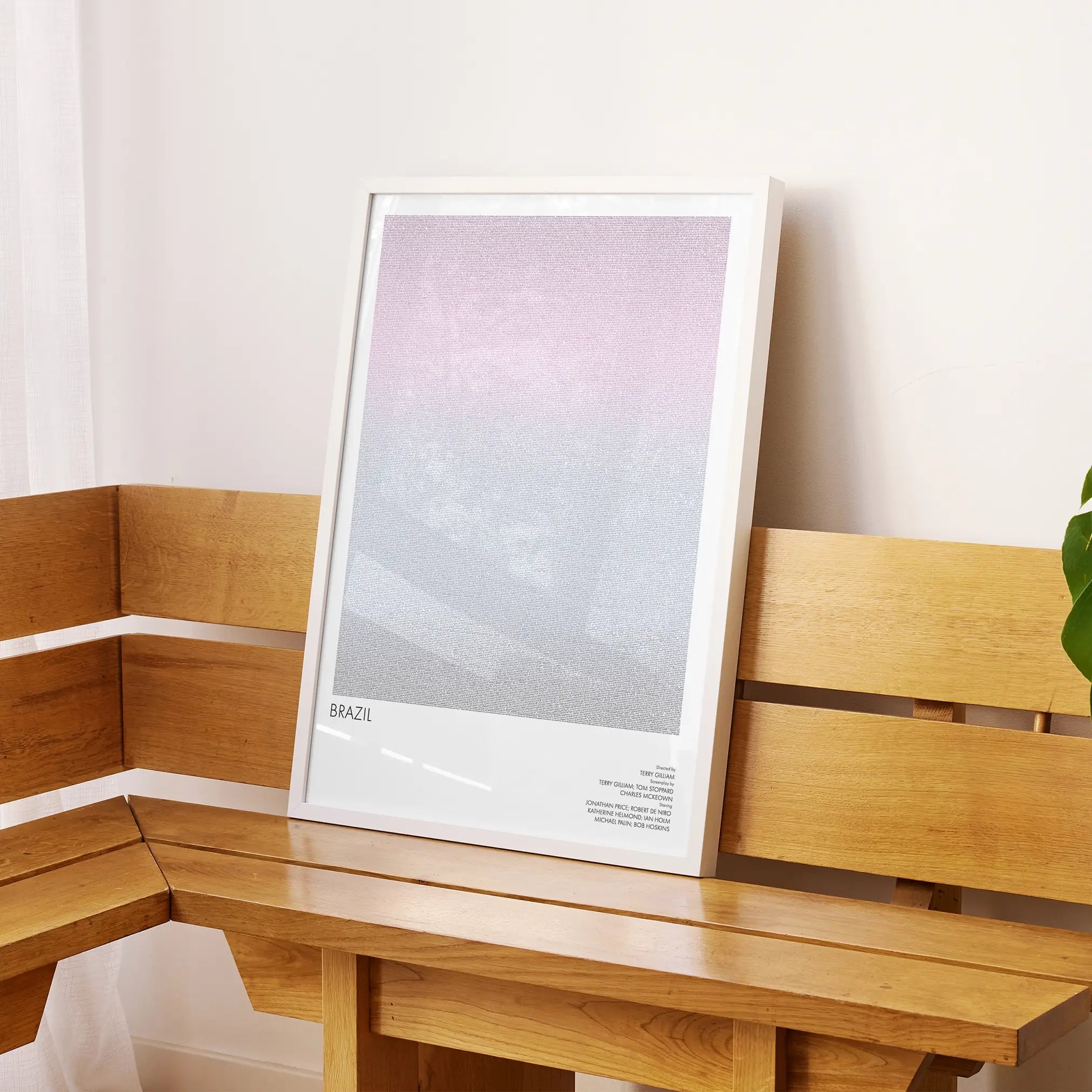 A framed Brazil movie script poster displayed on a sideboard in a contemporary space.