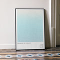 A framed Breakfast at Tiffany's movie script poster leaning against a wall in a minimalist interior.