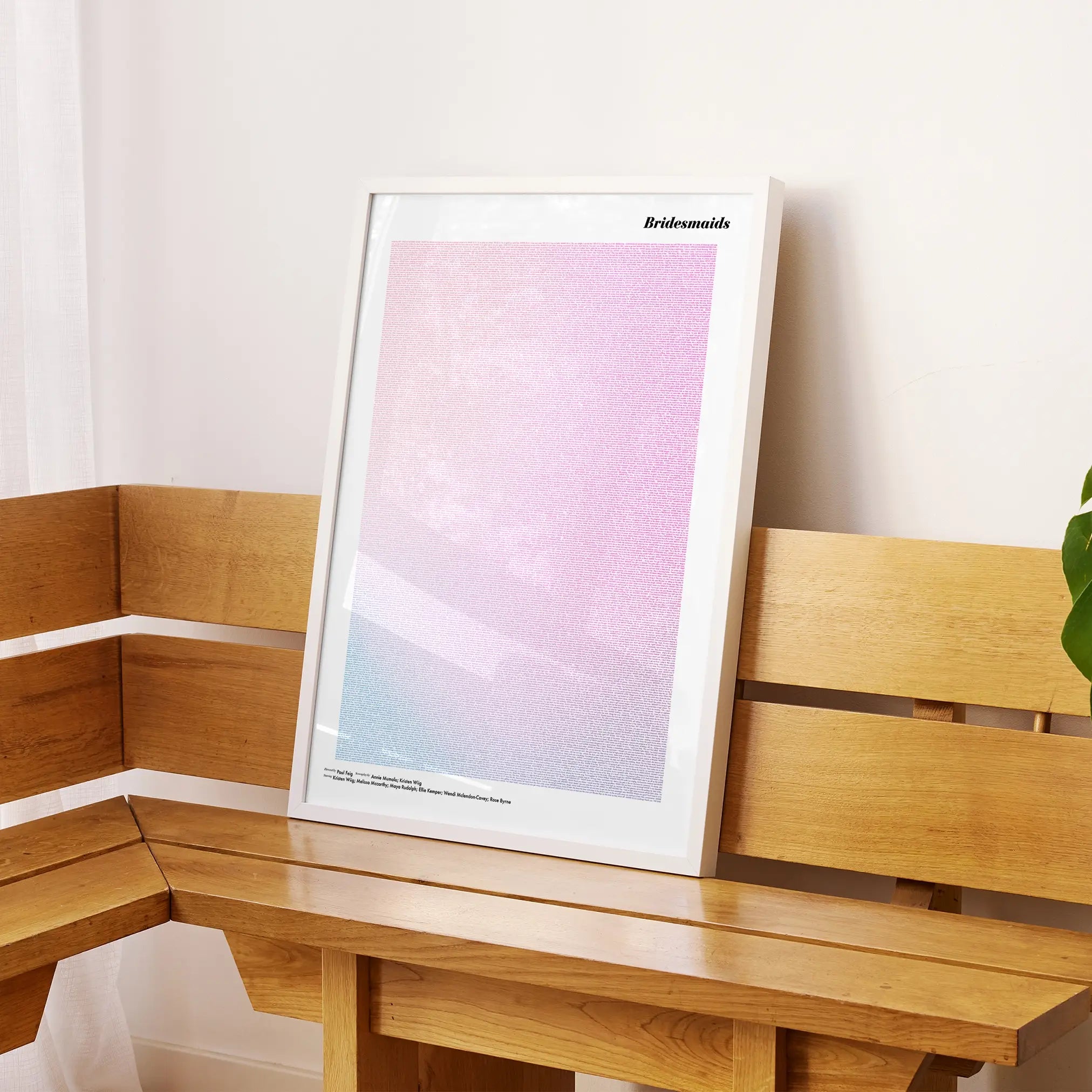 A framed Bridesmaids movie script poster displayed on a sideboard in a contemporary space.
