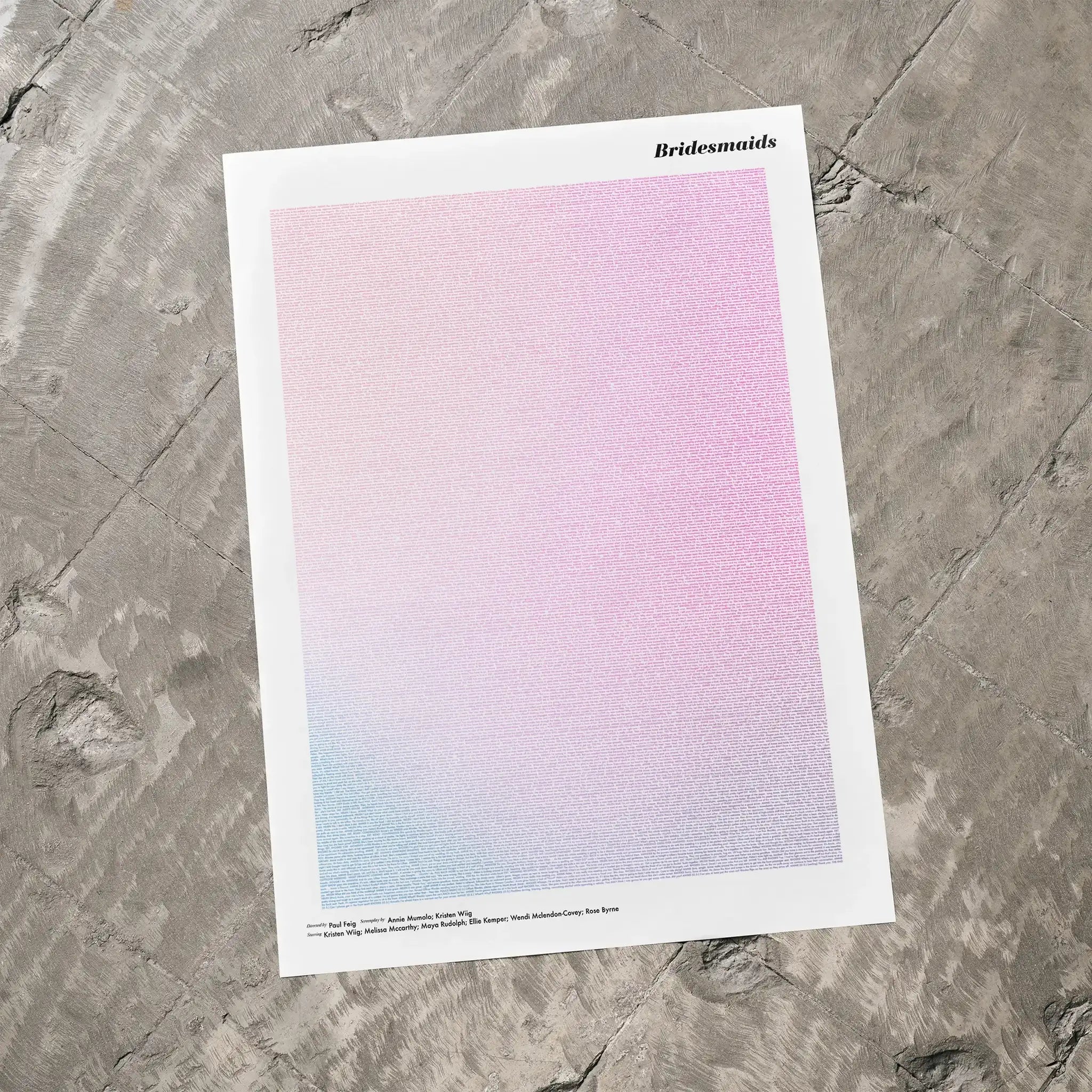 A Bridesmaids movie script poster laid flat on a textured floor surface.