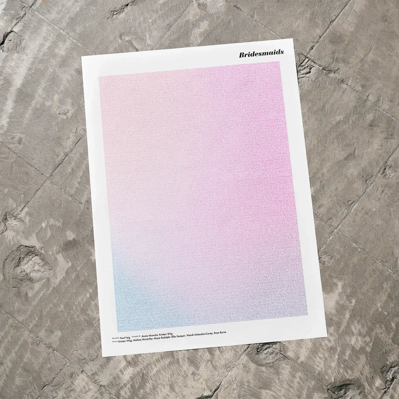 A Bridesmaids movie script poster laid flat on a textured floor surface.