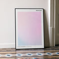 A framed Bridesmaids movie script poster leaning against a wall in a minimalist interior.