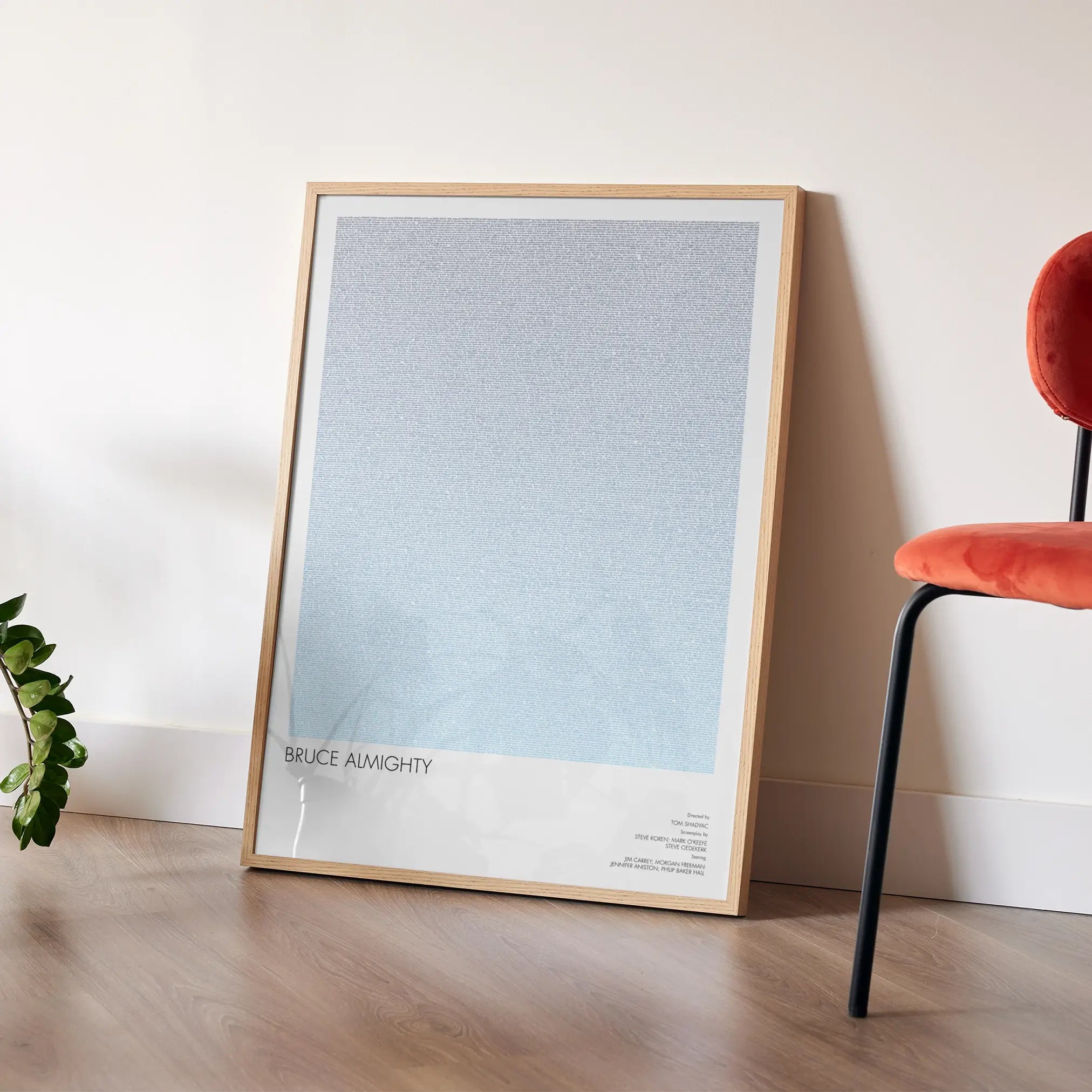 A framed Bruce Almighty movie script poster placed in a bright interior environment.