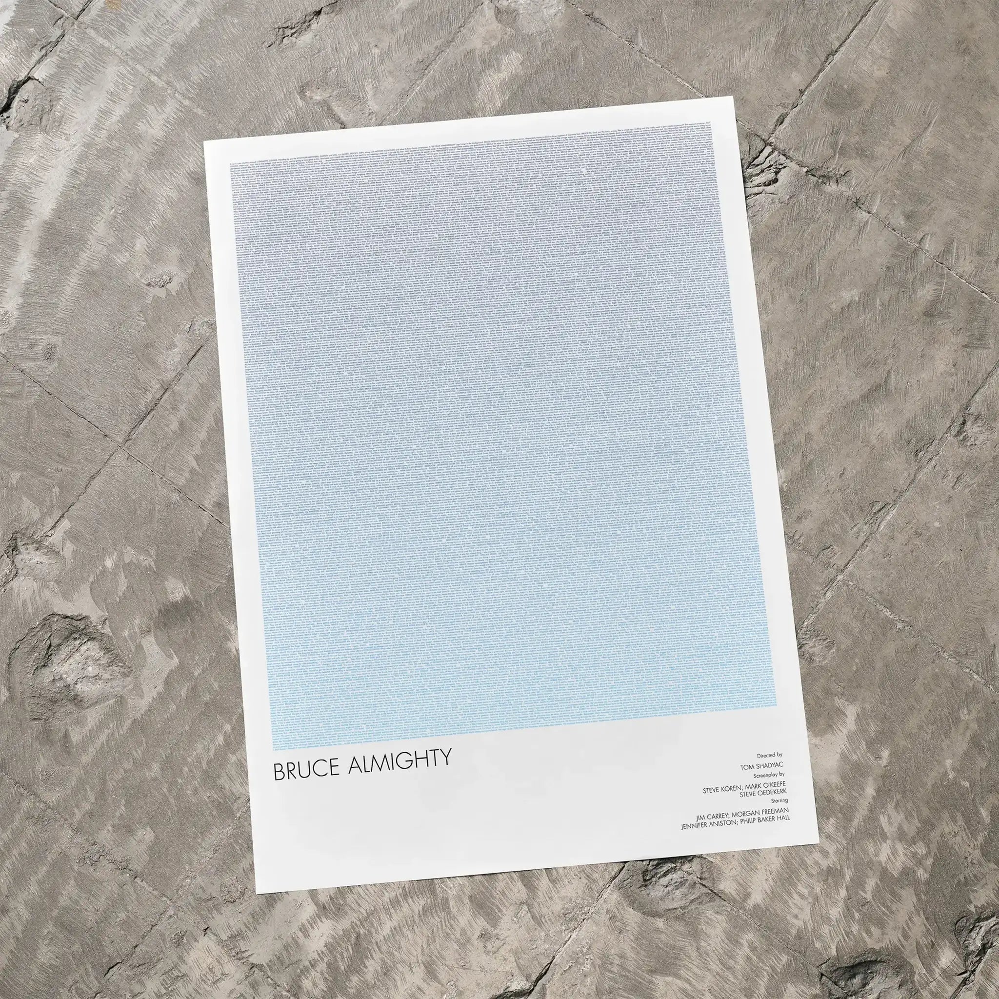 A Bruce Almighty movie script poster laid flat on a textured floor surface.