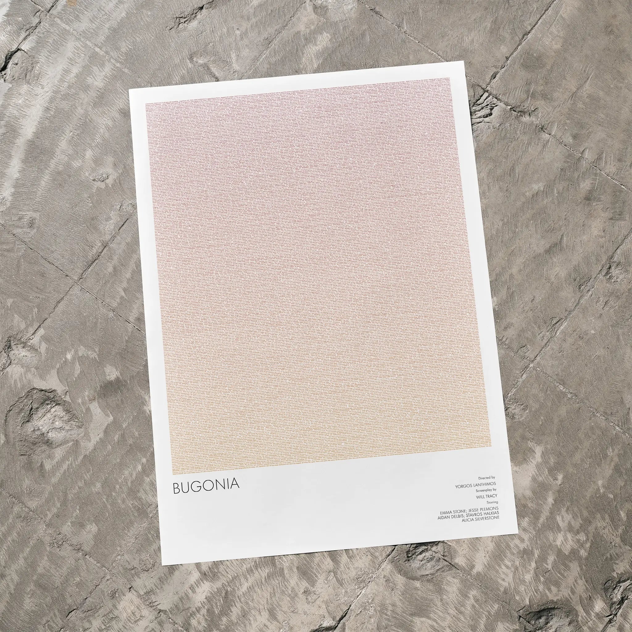 A Bugonia movie script poster laid flat on a textured floor surface.