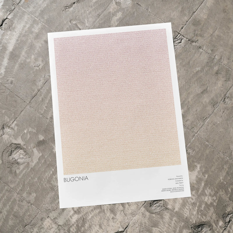 A Bugonia movie script poster laid flat on a textured floor surface.