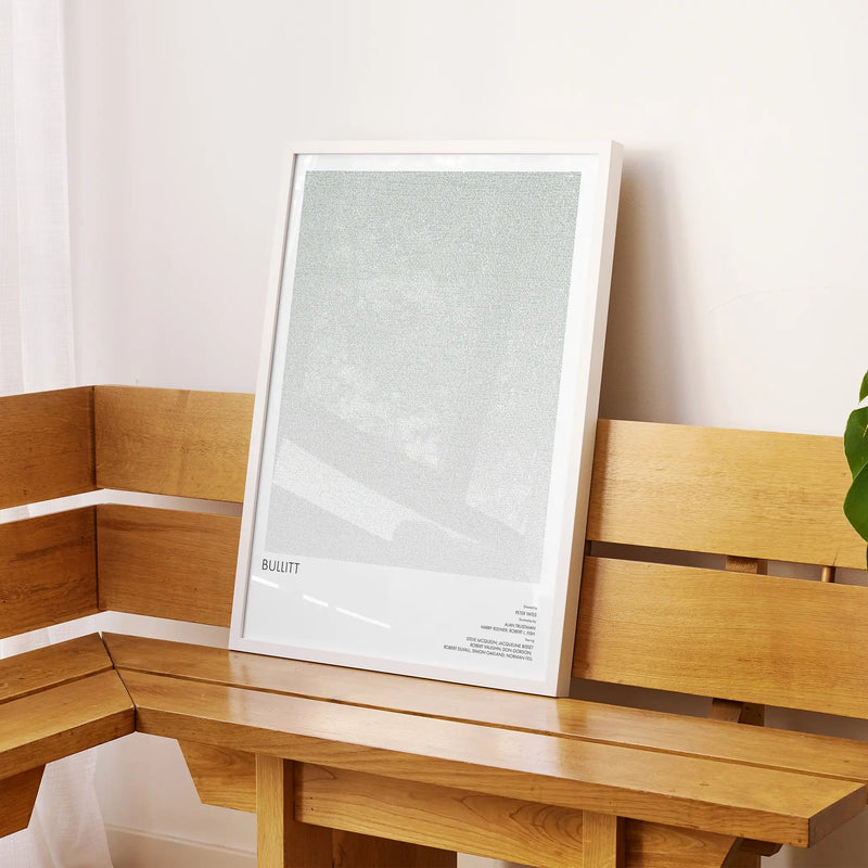 A framed Bullitt movie script poster displayed on a sideboard in a contemporary space.