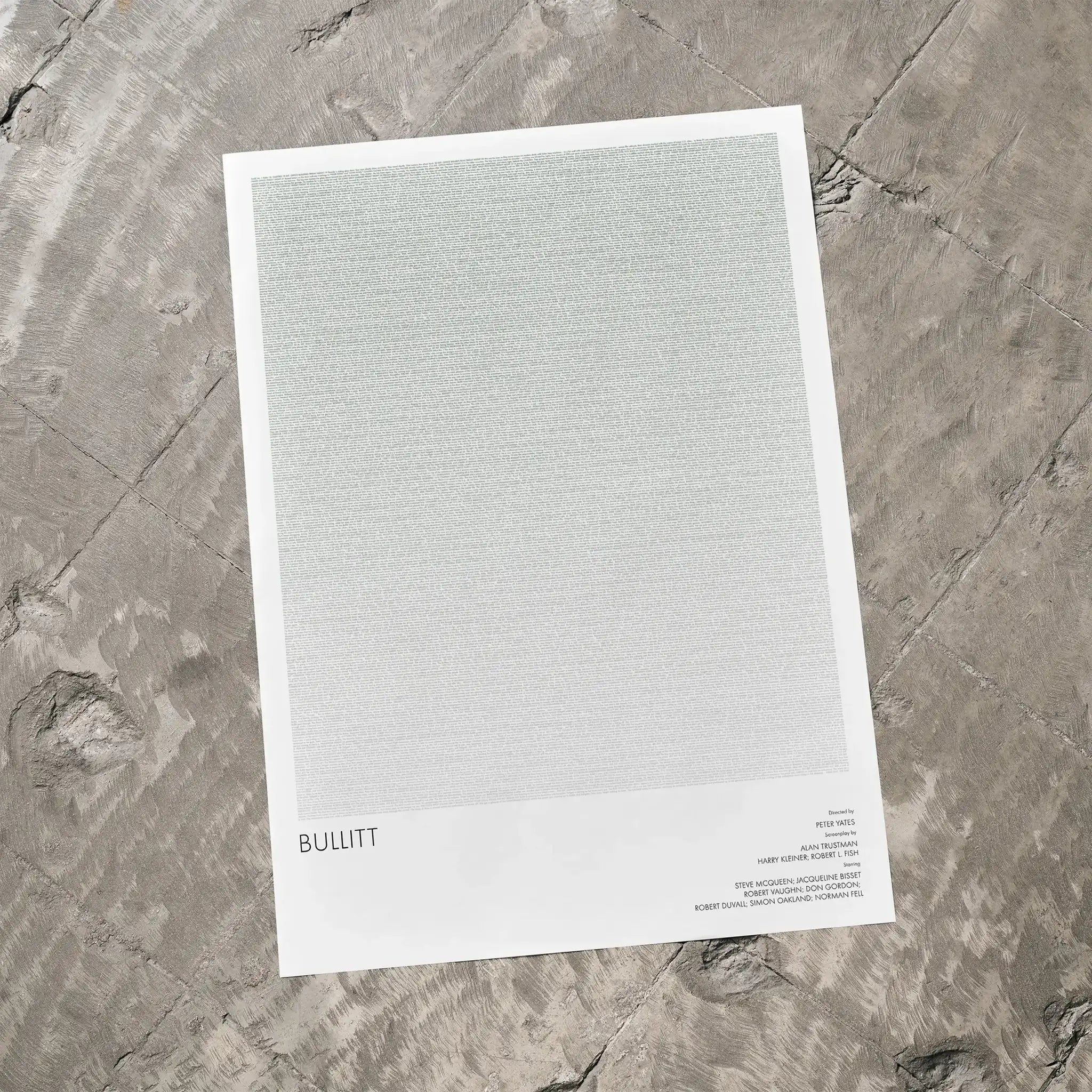 A Bullitt movie script poster laid flat on a textured floor surface.