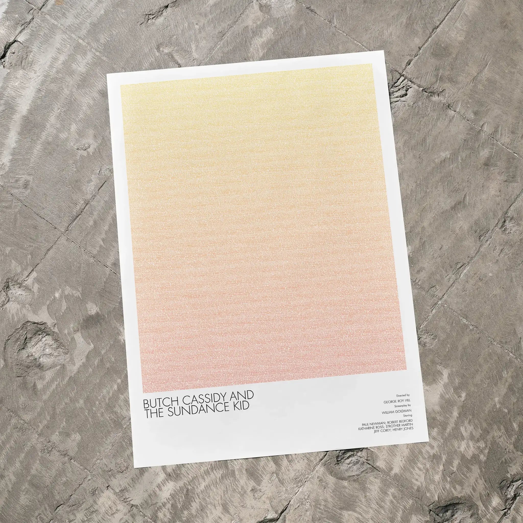 A Butch Cassidy and the Sundance Kid movie script poster laid flat on a textured floor surface.