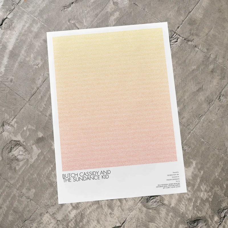 A Butch Cassidy and the Sundance Kid movie script poster laid flat on a textured floor surface.