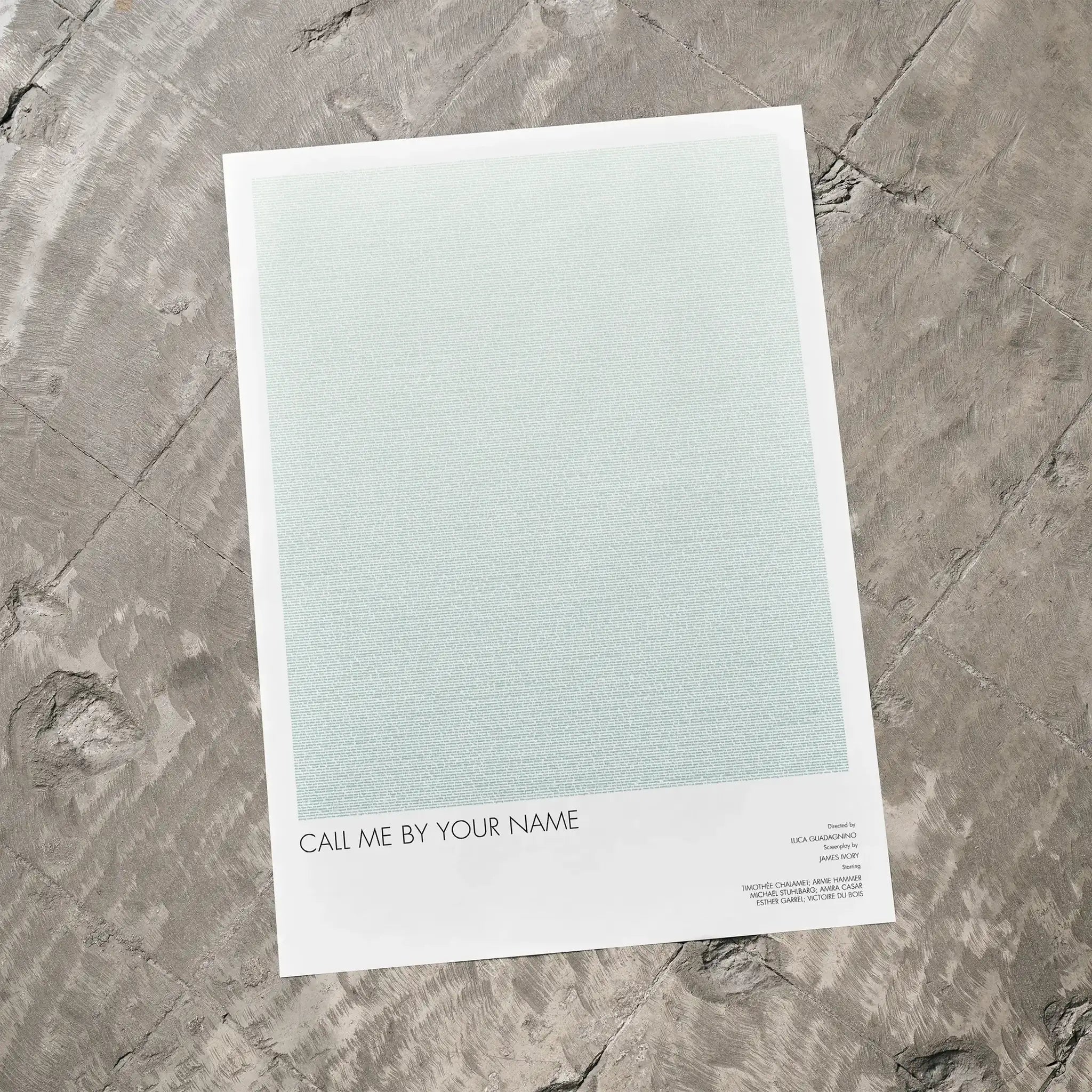 A Call Me by Your Name movie script poster laid flat on a textured floor surface.