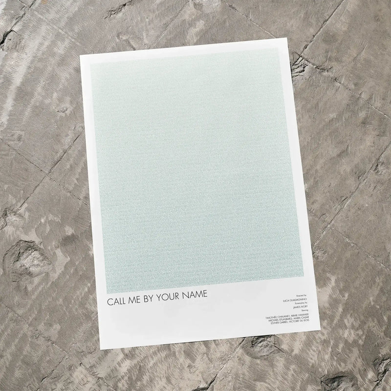 A Call Me by Your Name movie script poster laid flat on a textured floor surface.