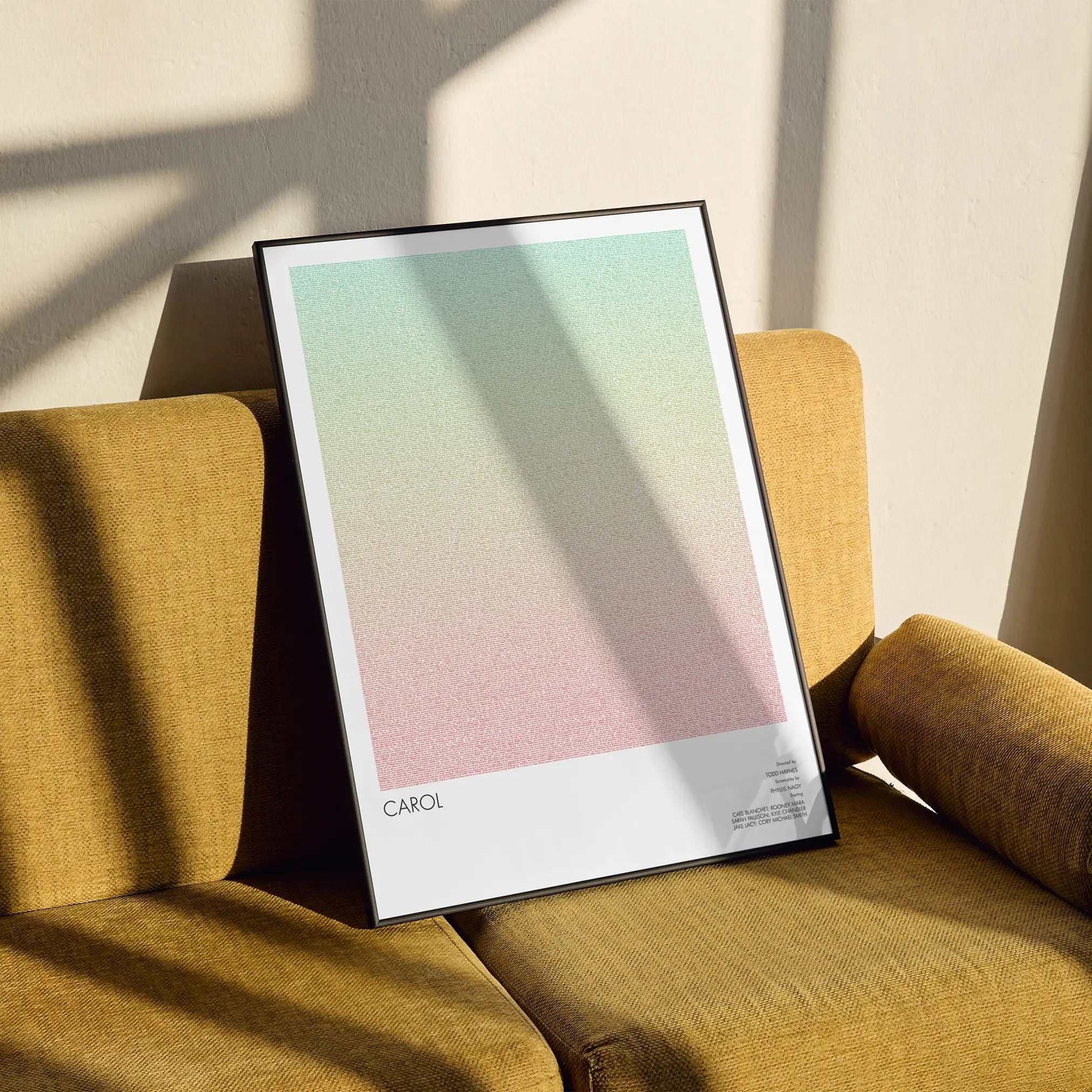 A framed Carol movie script poster styled in a clean interior setting.