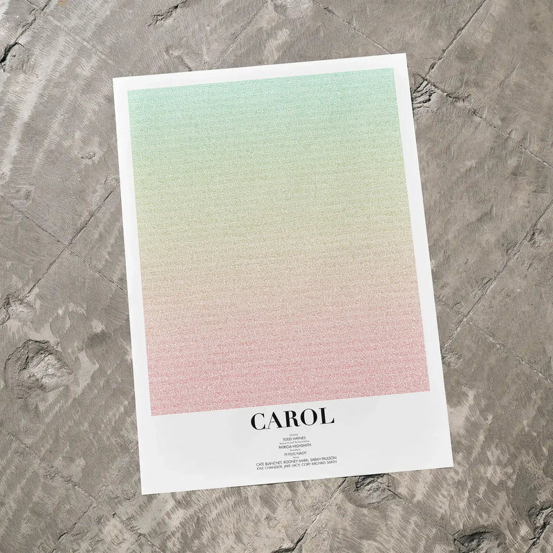 A Carol movie script poster laid flat on a textured floor surface.