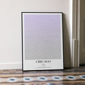 A framed Chicago movie script poster leaning against a wall in a minimalist interior.