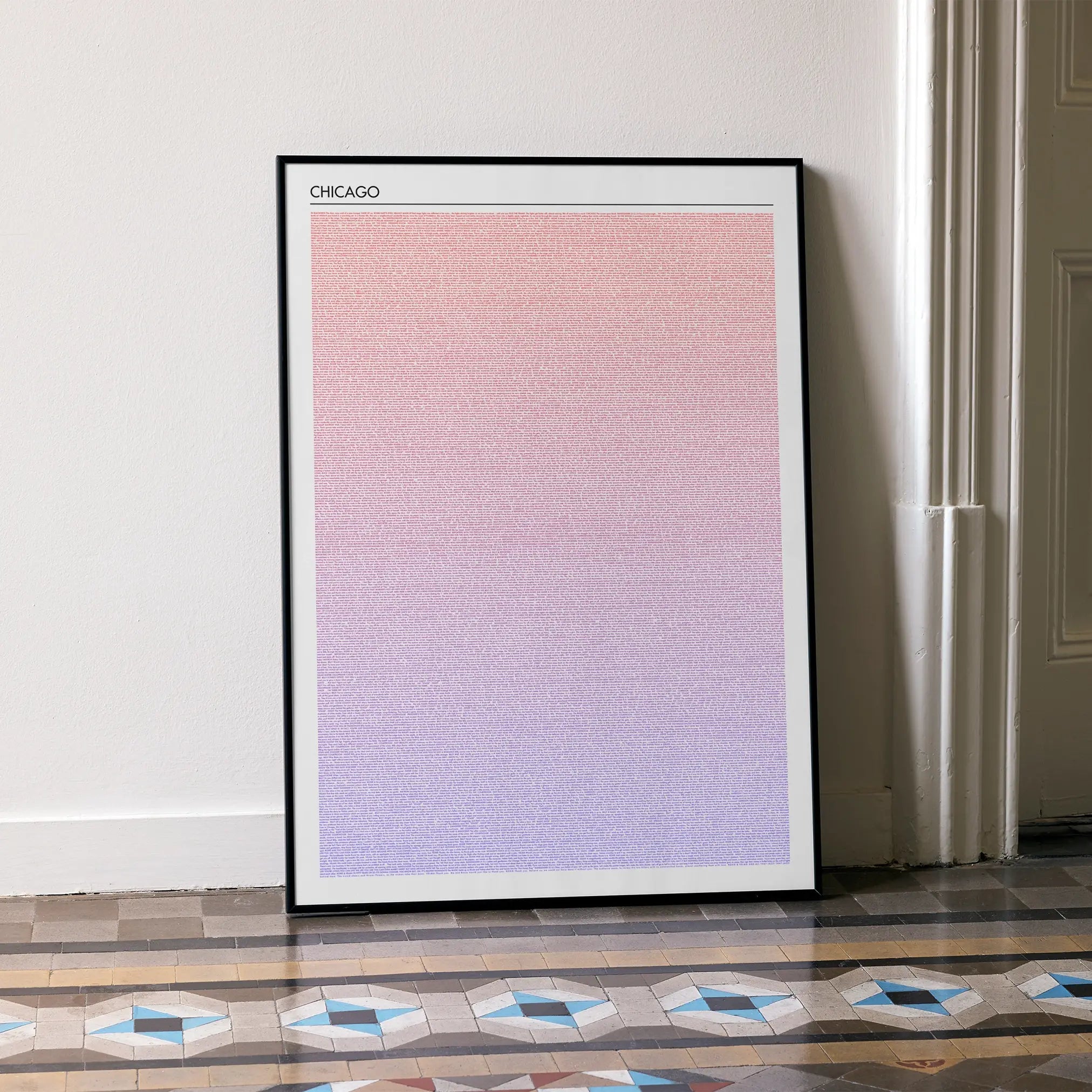 A framed Chicago movie script poster leaning against a wall in a minimalist interior.