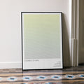 A framed Children of Men movie script poster leaning against a wall in a minimalist interior.