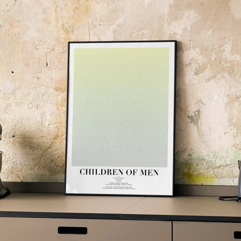 A framed Children of Men movie script poster displayed on a cabinet in a minimalist interior.