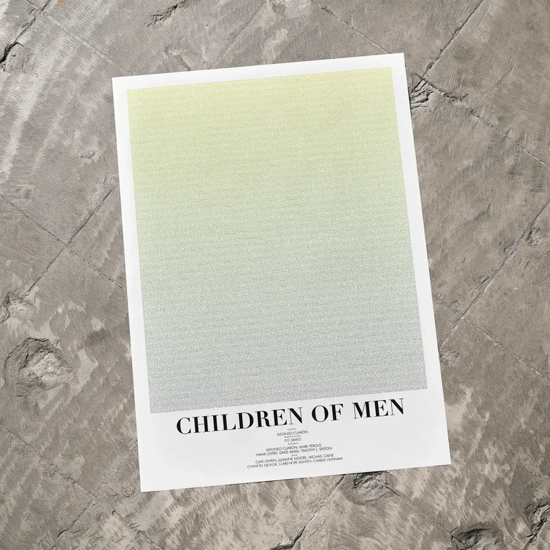 A Children of Men movie script poster laid flat on a textured floor surface.