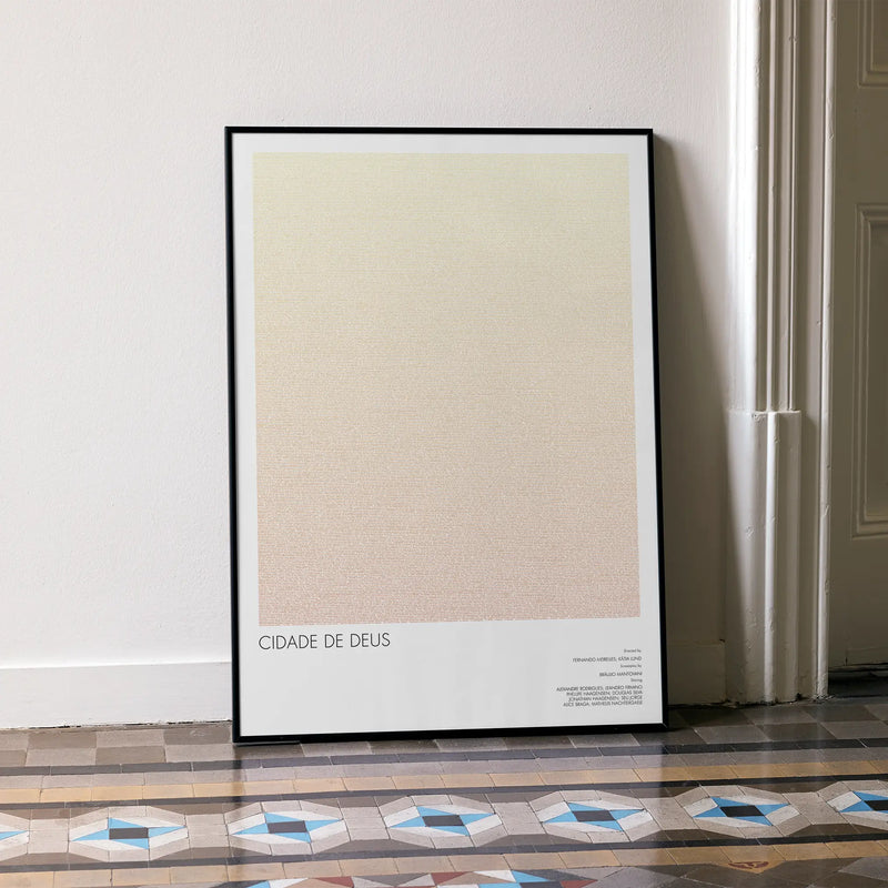 A framed Cidade de Deus movie script poster leaning against a wall in a minimalist interior.