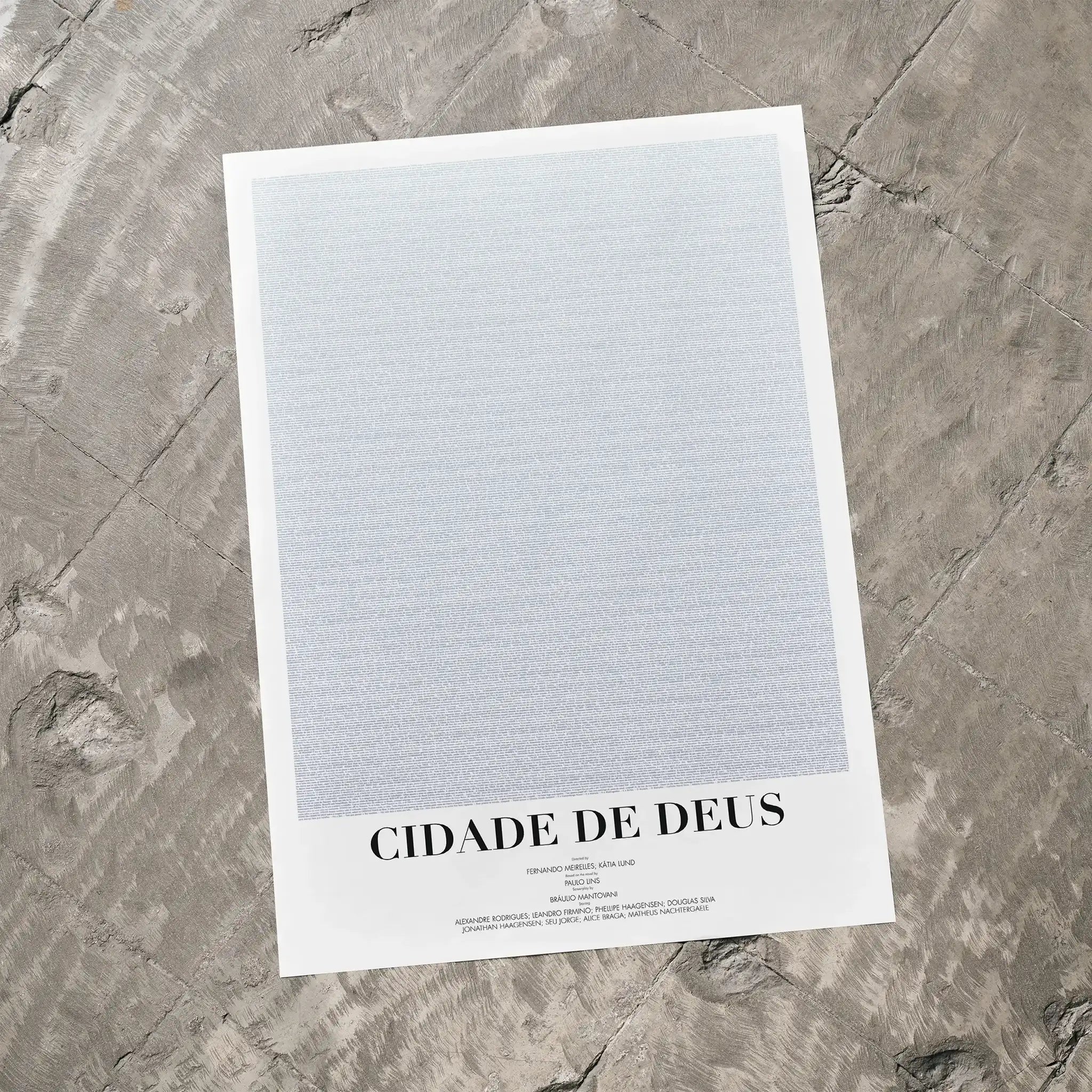 A Cidade de Deus movie script poster laid flat on a textured floor surface.