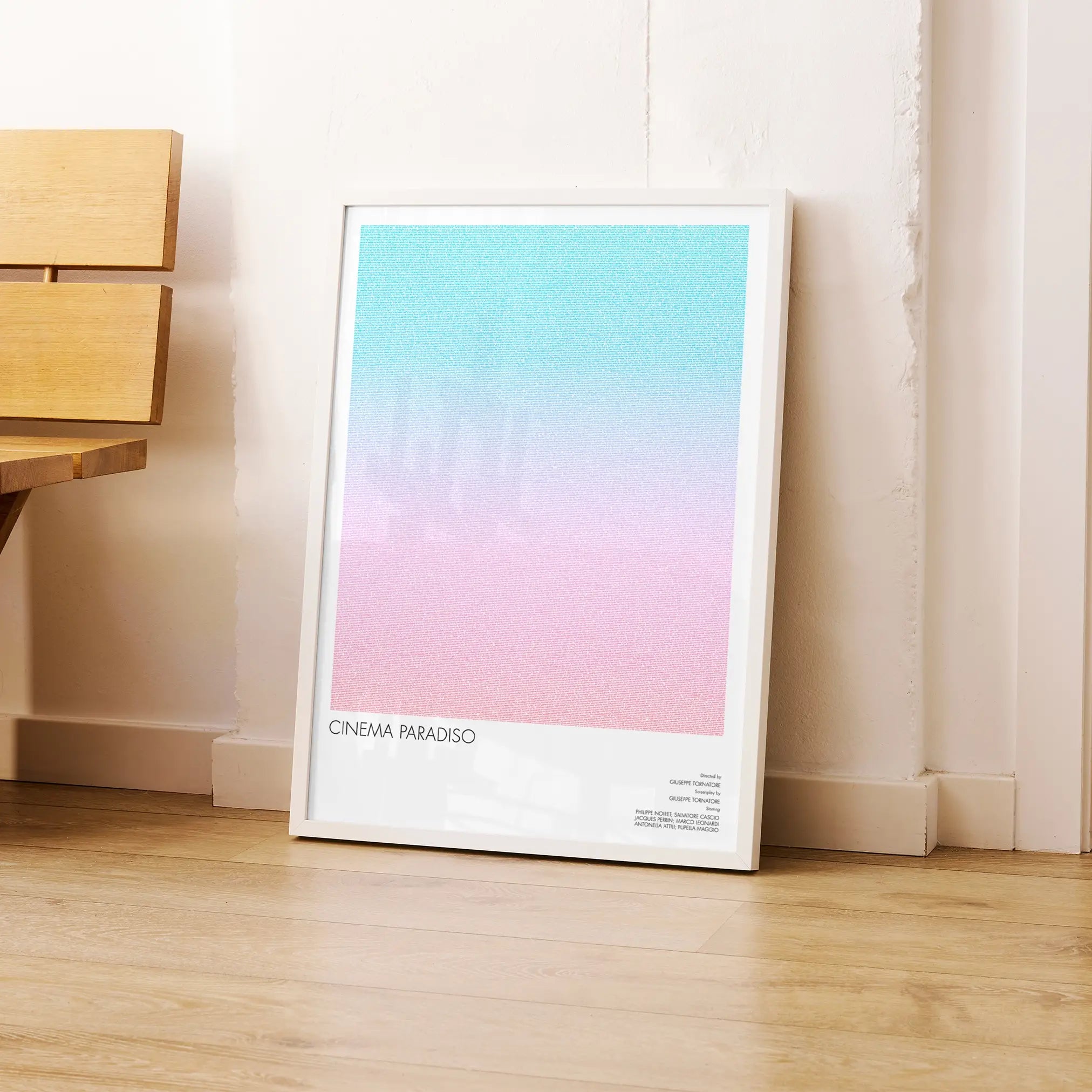 A framed Cinema Paradiso movie script poster leaning against a wall in a modern interior.