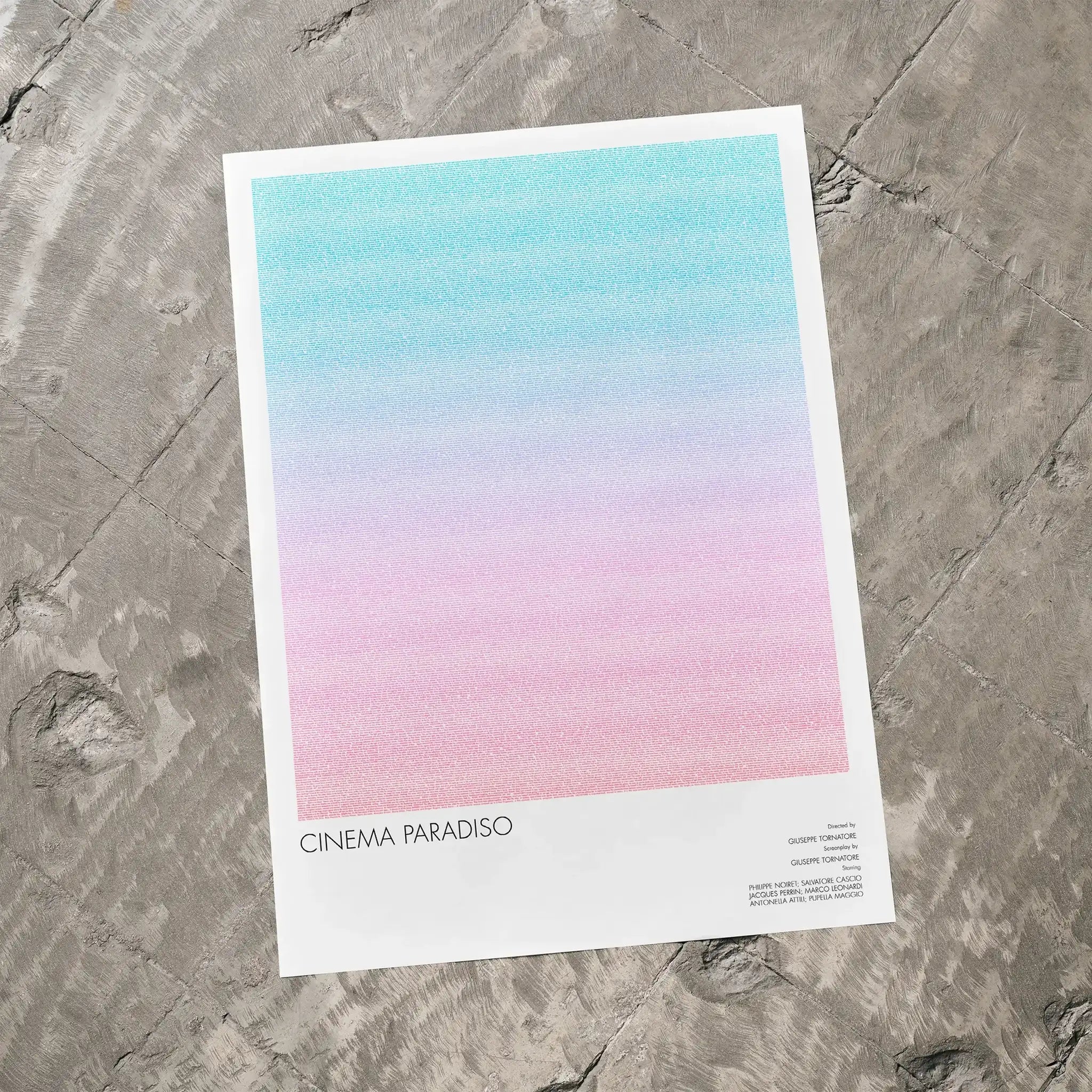 A Cinema Paradiso movie script poster laid flat on a textured floor surface.