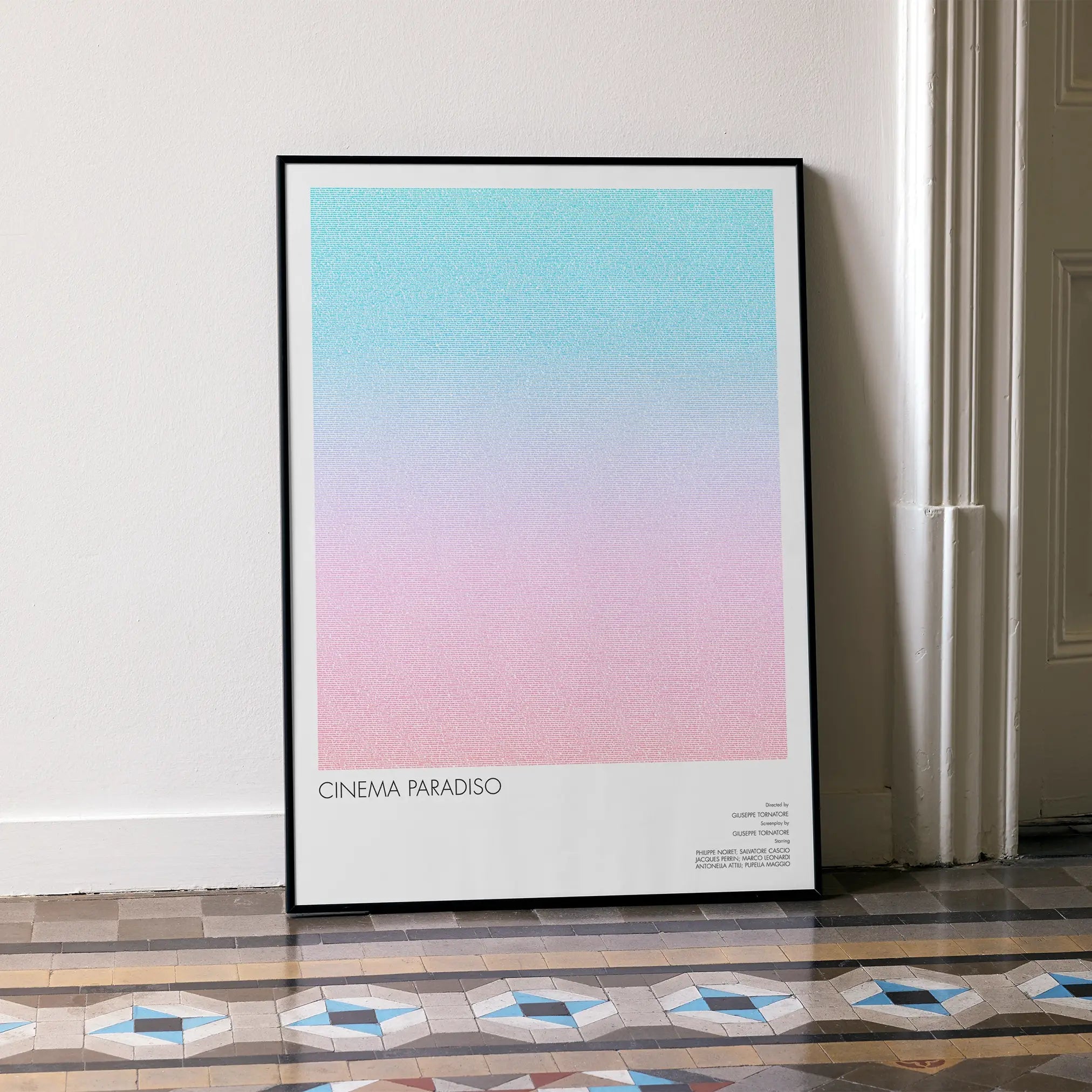 A framed Cinema Paradiso movie script poster leaning against a wall in a minimalist interior.