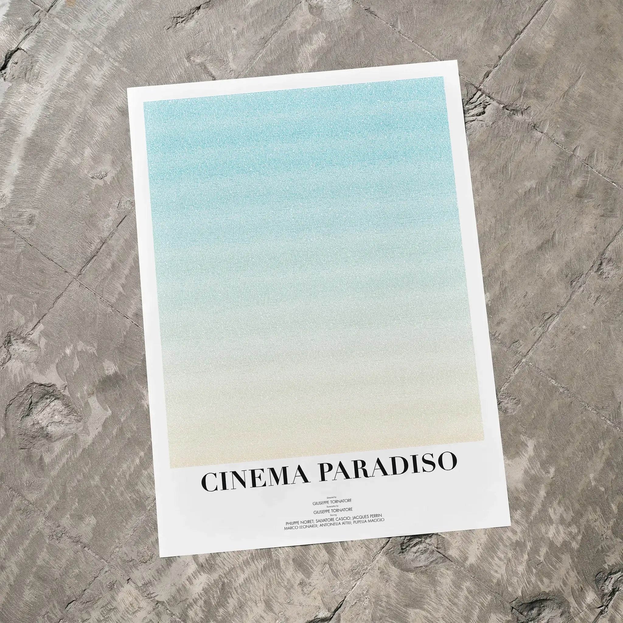 A Cinema Paradiso movie script poster laid flat on a textured floor surface.