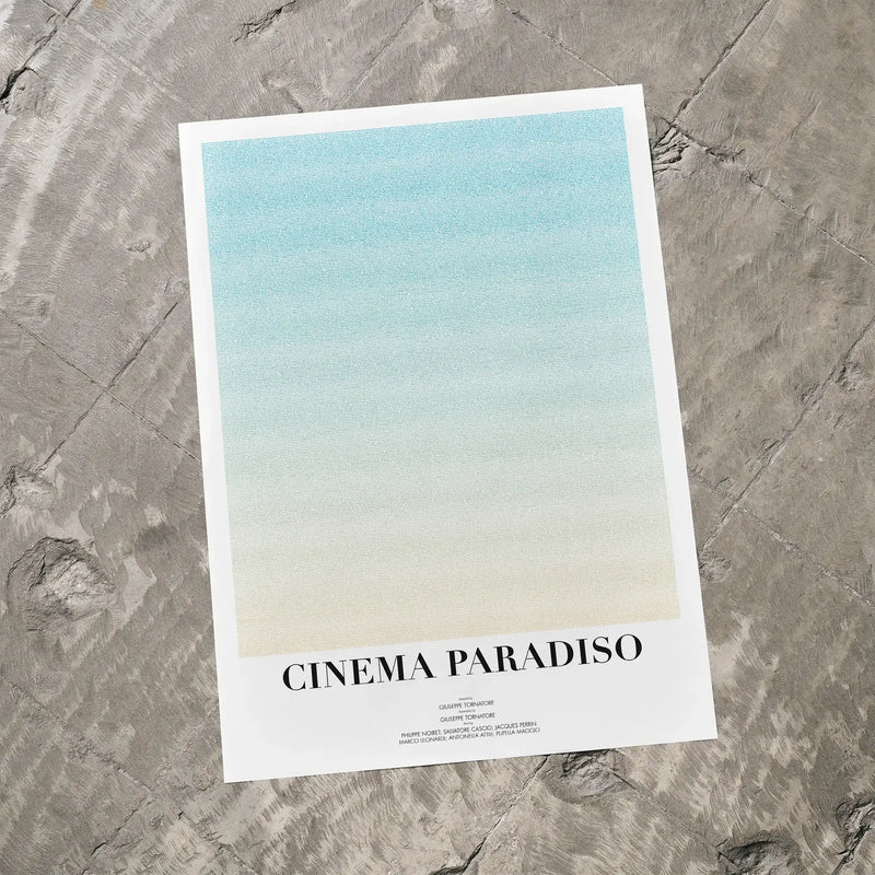 A Cinema Paradiso movie script poster laid flat on a textured floor surface.