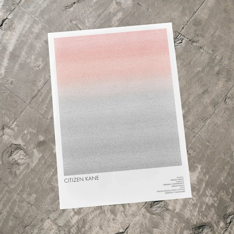 A Citizen Kane movie script poster laid flat on a textured floor surface.