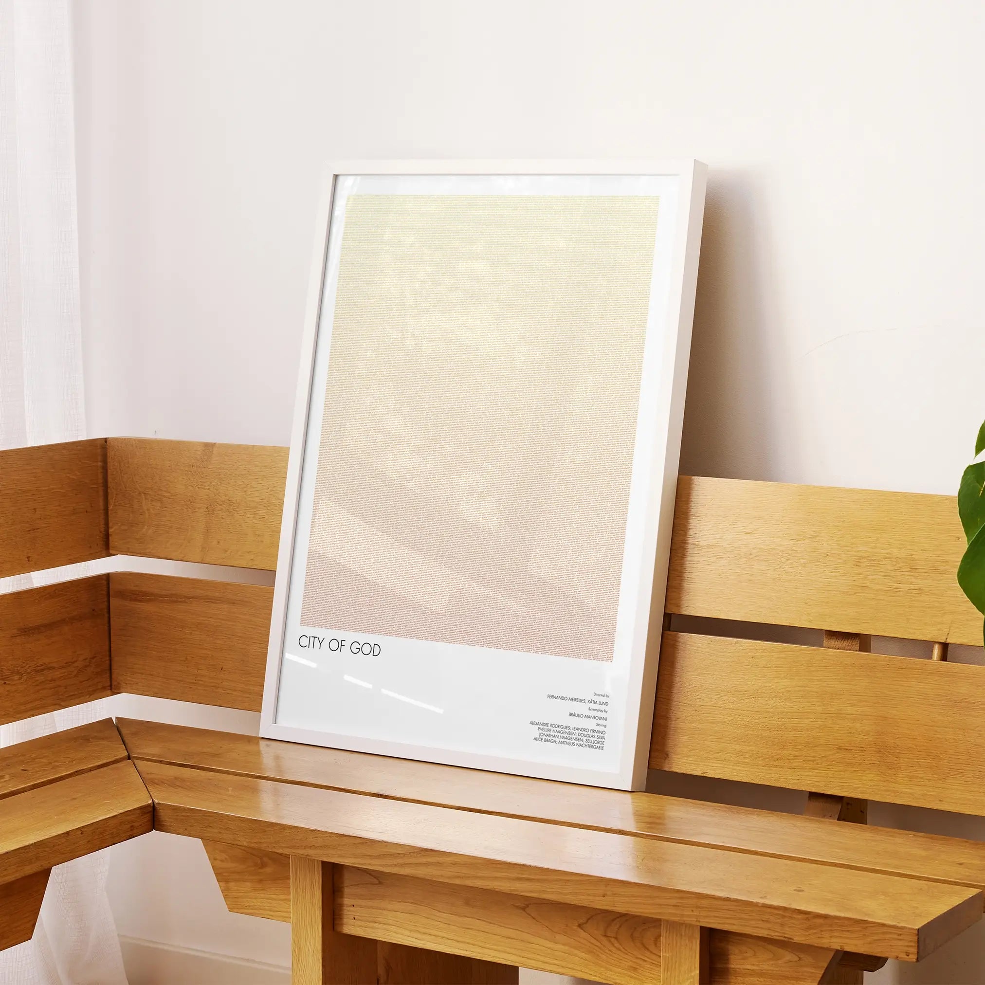 A framed City of God movie script poster displayed on a sideboard in a contemporary space.