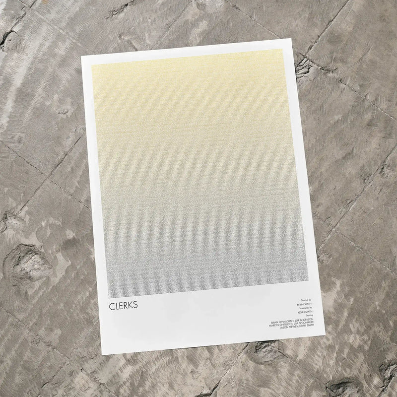 A Clerks movie script poster laid flat on a textured floor surface.