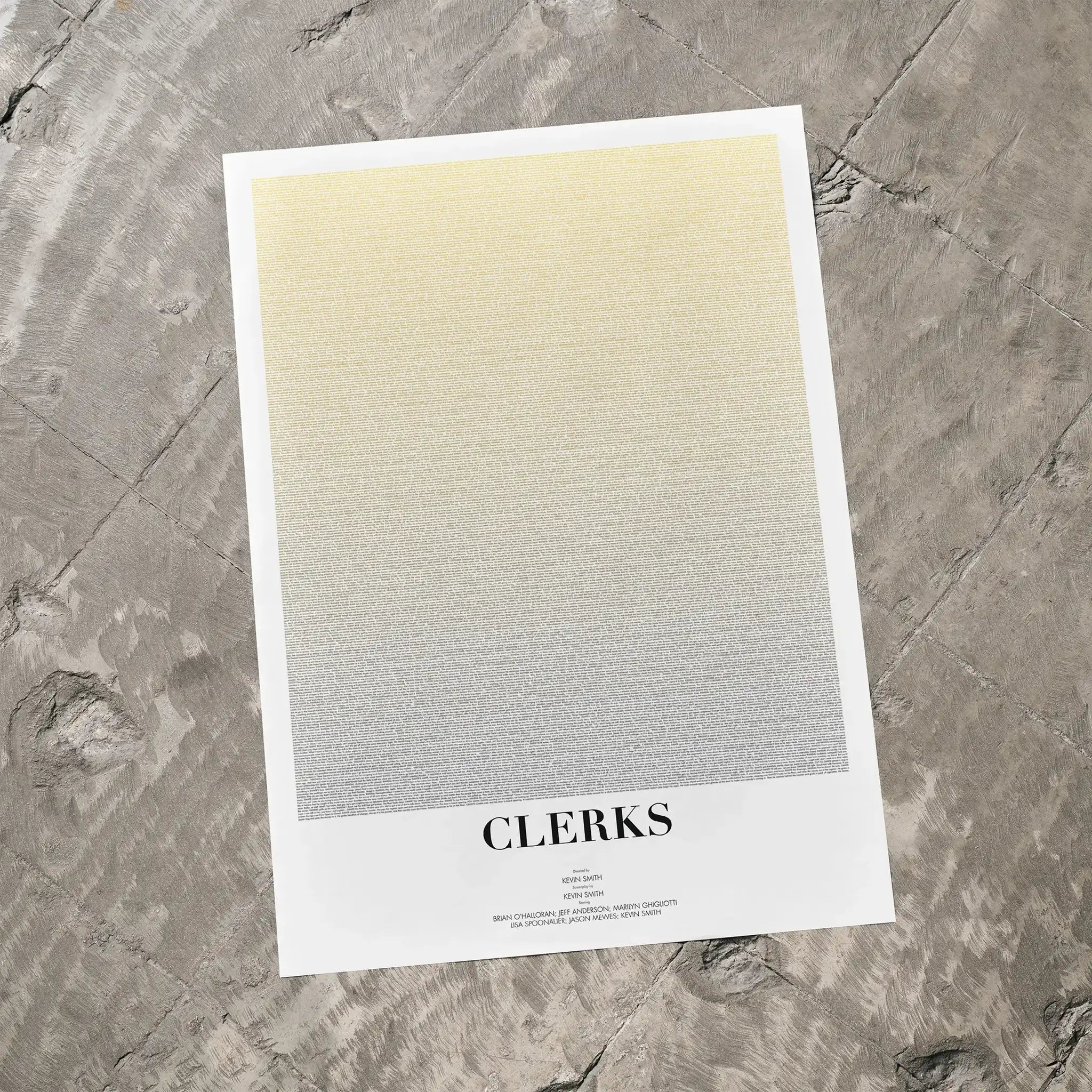 A Clerks movie script poster laid flat on a textured floor surface.