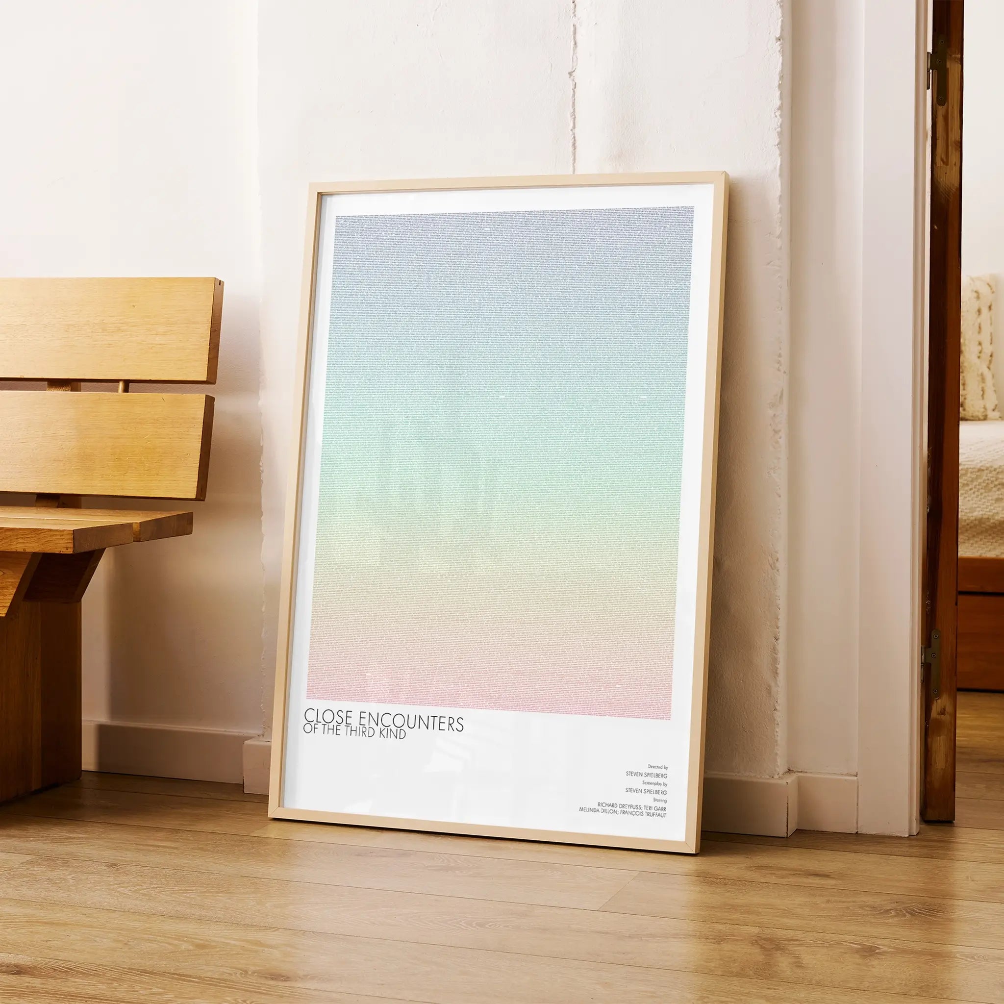 A framed Close Encounters of the Third Kind movie script poster arranged in a minimalist interior setting.