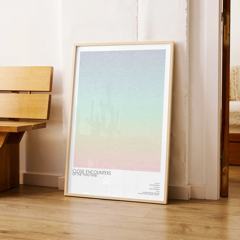 A framed Close Encounters of the Third Kind movie script poster arranged in a minimalist interior setting.
