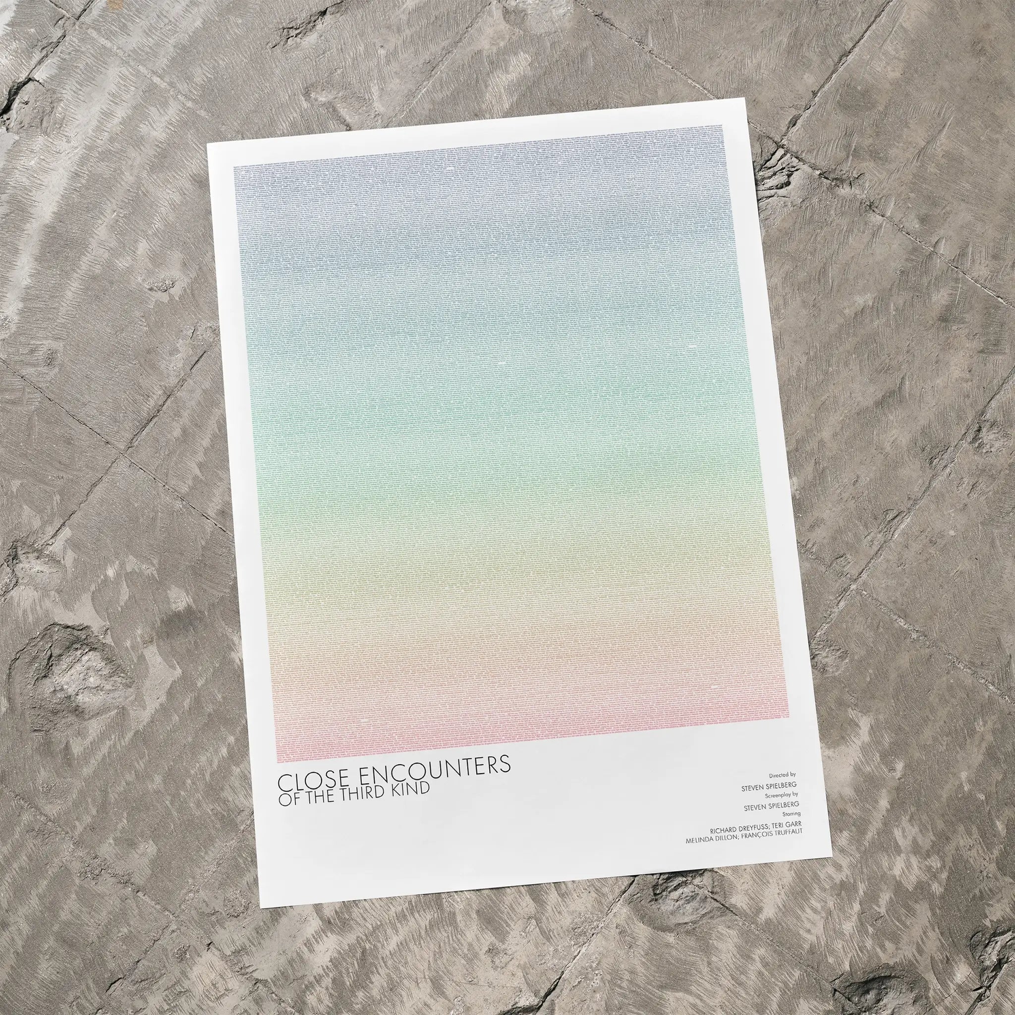 A Close Encounters of the Third Kind movie script poster laid flat on a textured floor surface.