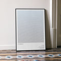 A framed Contact movie script poster leaning against a wall in a minimalist interior.