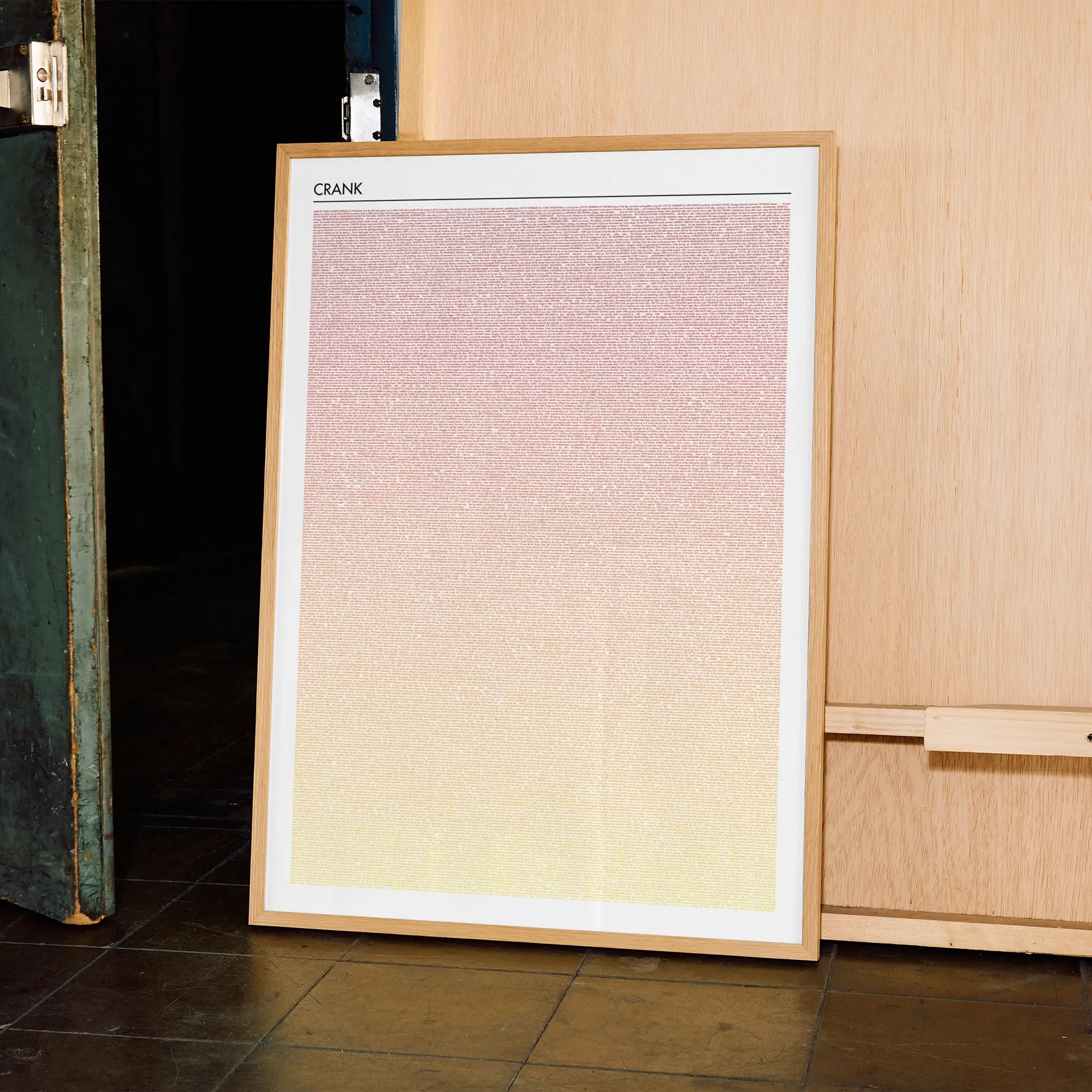 A framed Crank movie script poster displayed in a contemporary interior setting.