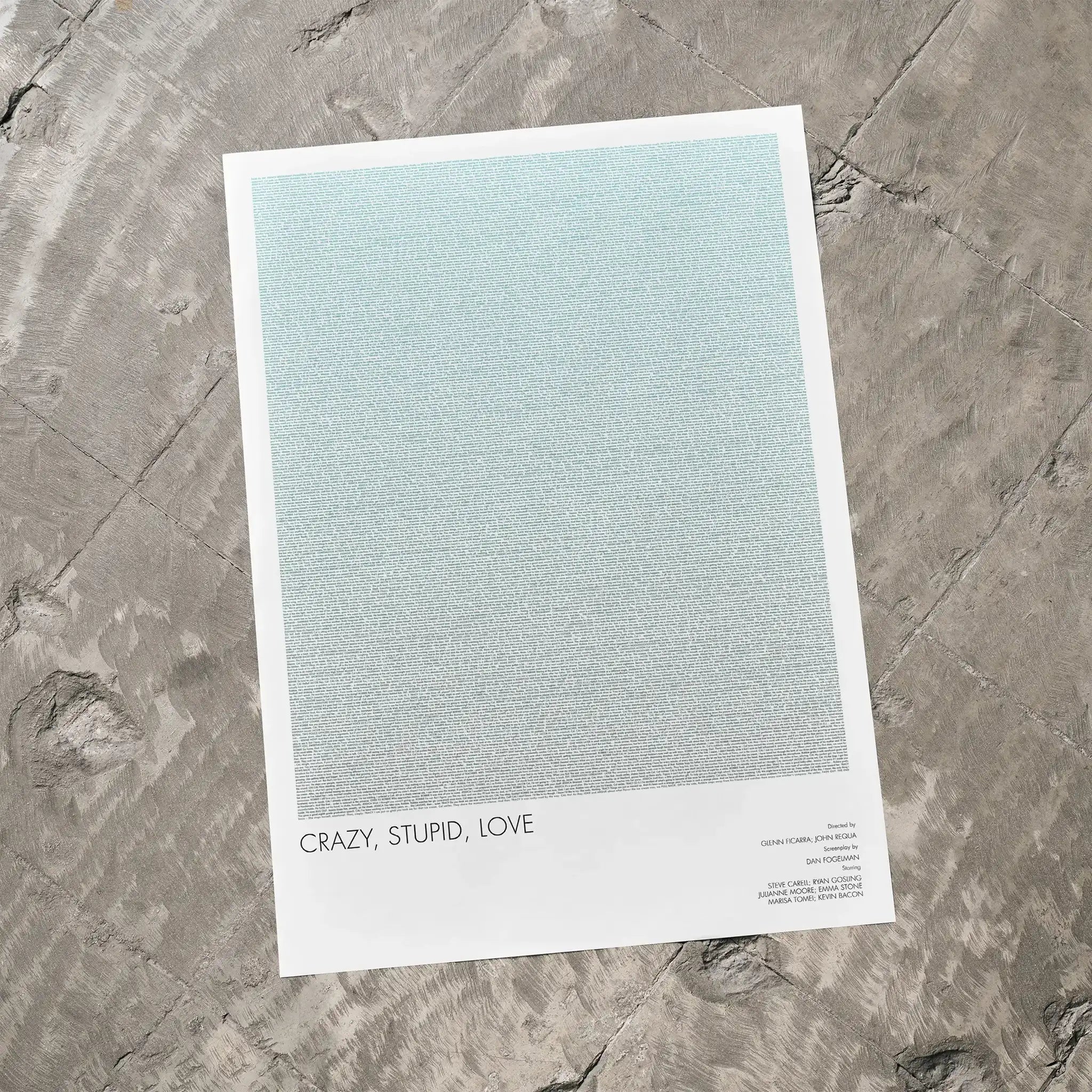 A Crazy, Stupid, Love movie script poster laid flat on a textured floor surface.