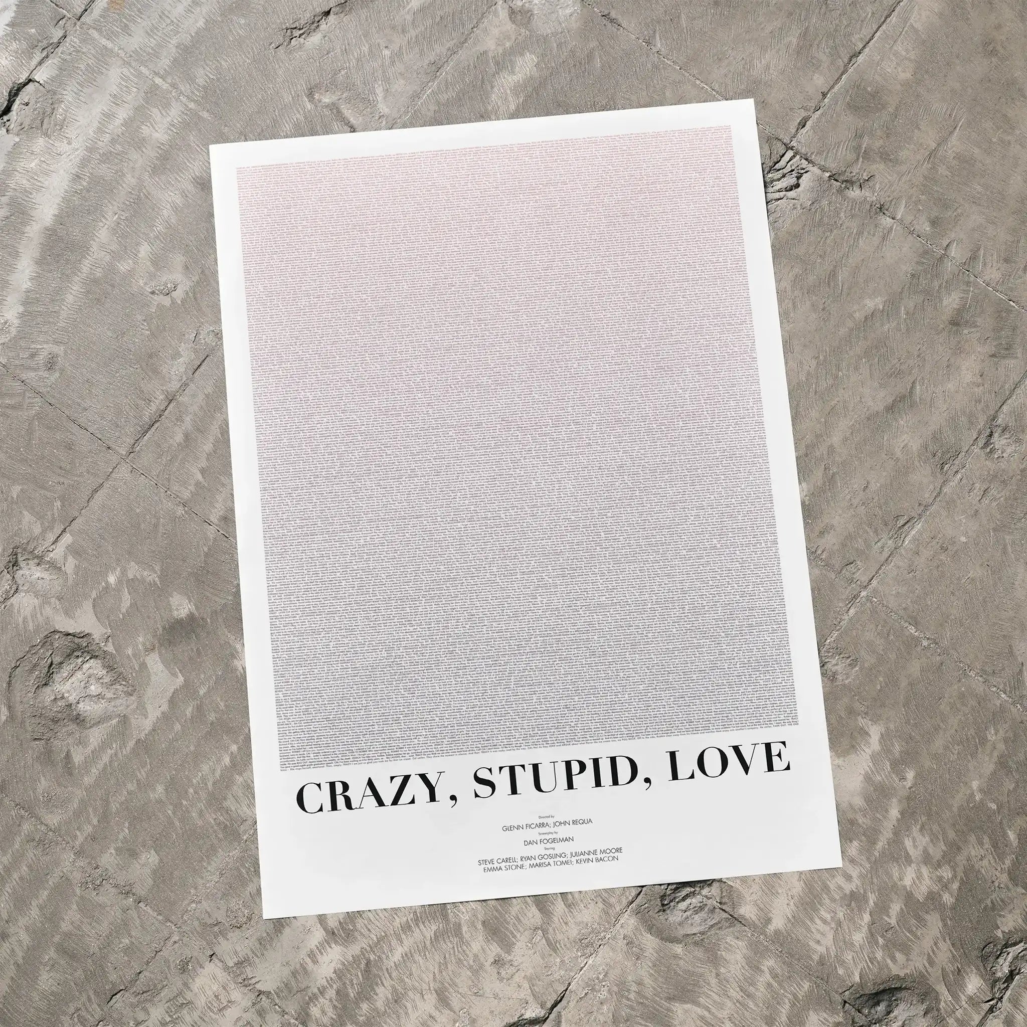 A Crazy, Stupid, Love. movie script poster laid flat on a textured floor surface.
