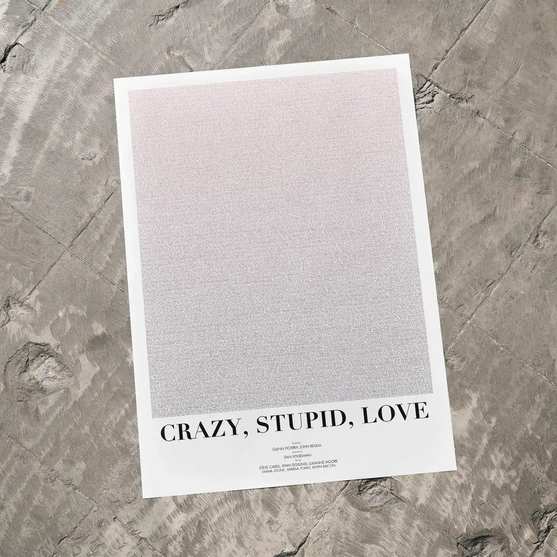 A Crazy, Stupid, Love. movie script poster laid flat on a textured floor surface.