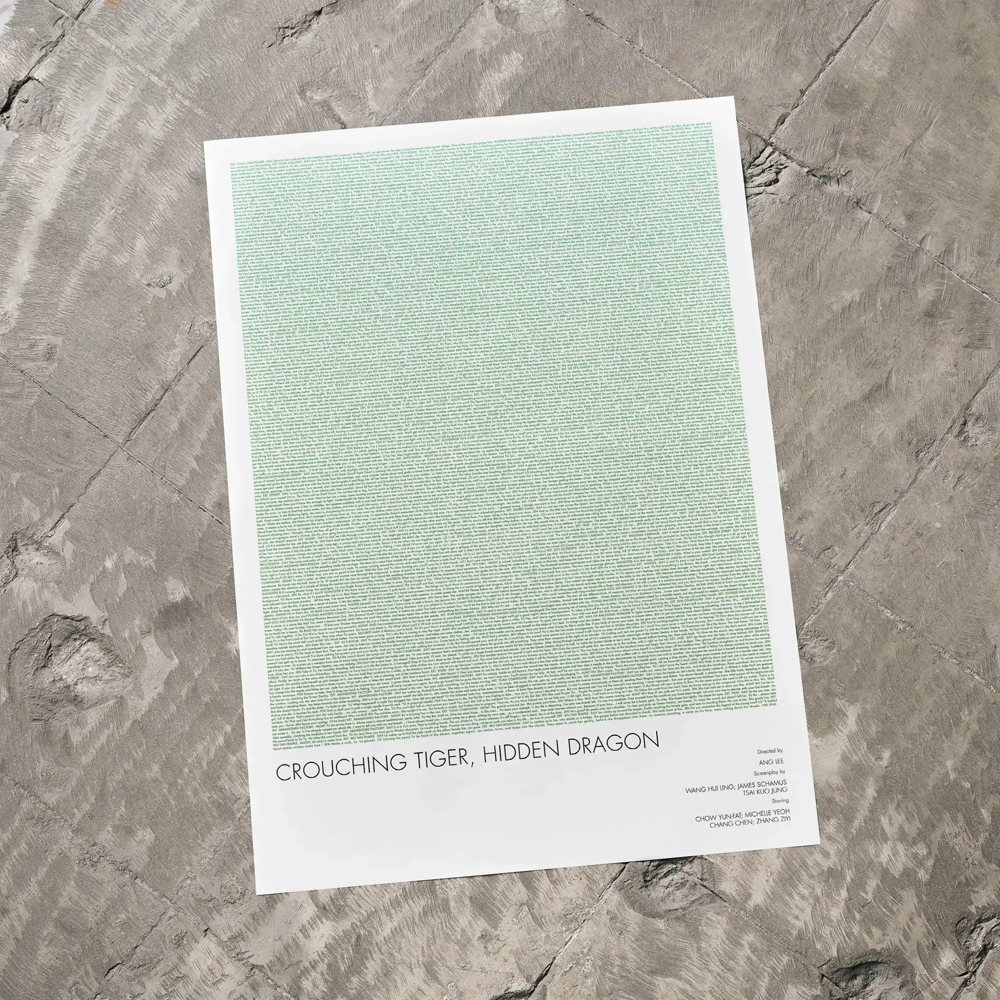 A Crouching Tiger, Hidden Dragon movie script poster laid flat on a textured floor surface.