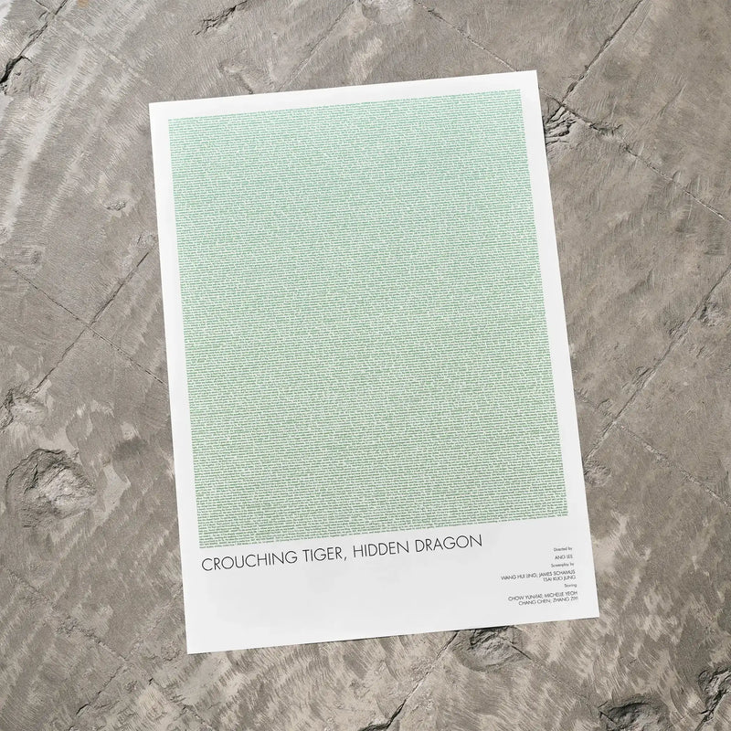 A Crouching Tiger, Hidden Dragon movie script poster laid flat on a textured floor surface.