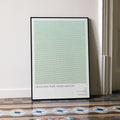 A framed Crouching Tiger, Hidden Dragon movie script poster leaning against a wall in a minimalist interior.