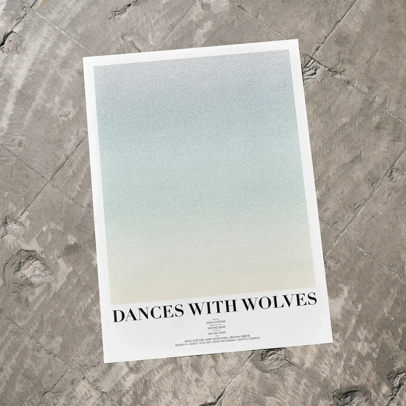 A Dances with Wolves movie script poster laid flat on a textured floor surface.