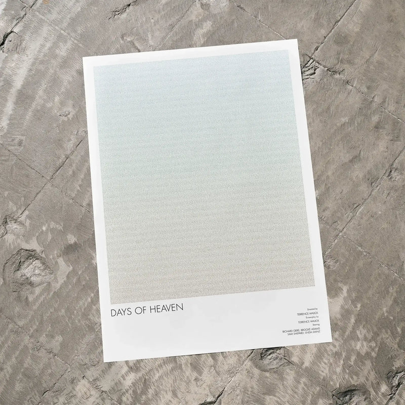 A Days of Heaven movie script poster laid flat on a textured floor surface.
