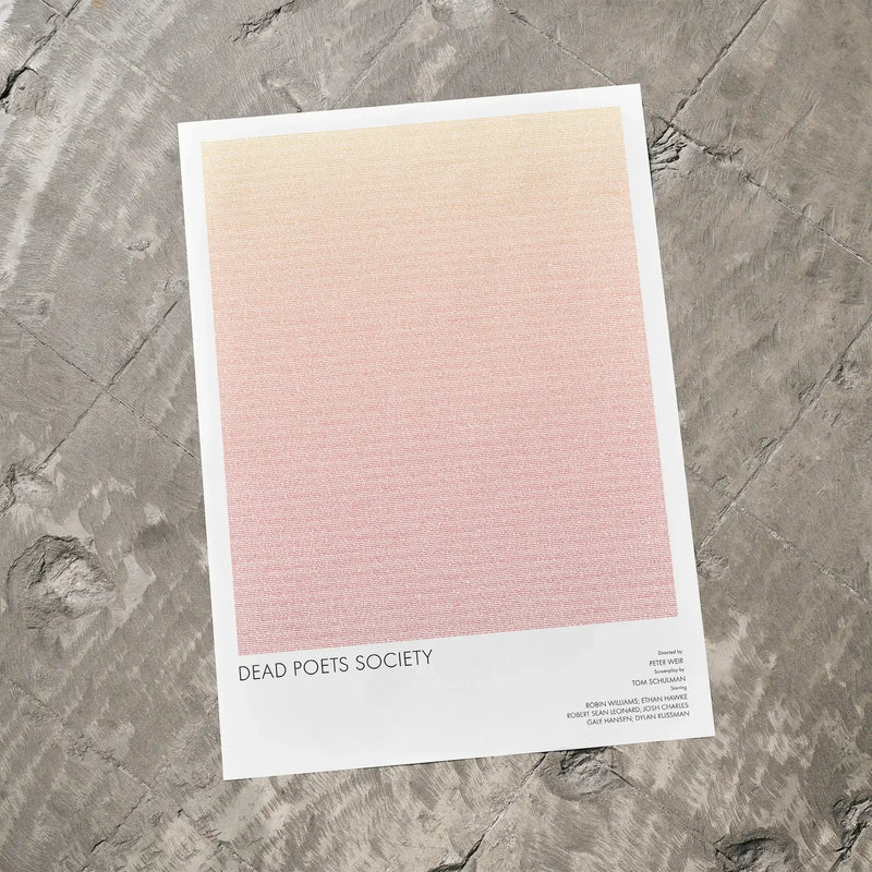 A Dead Poets Society movie script poster laid flat on a textured floor surface.