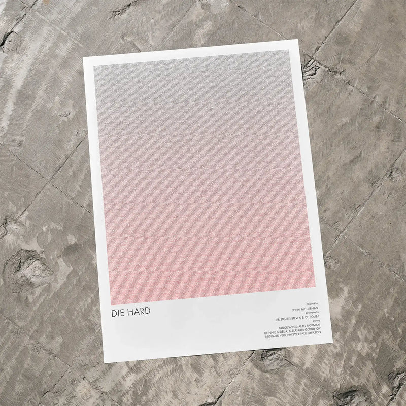 A Die Hard movie script poster laid flat on a textured floor surface.